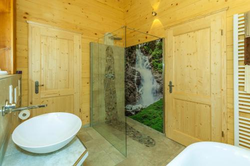 a bathroom with a shower and a toilet and a sink at Chalet unter weiß-blauem Himmel in Reit im Winkl