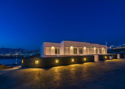 a building with lights in front of it at night at Cape Mykonos in Mýkonos City