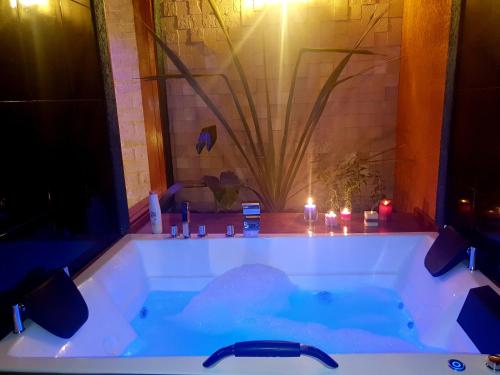 a bathroom with a tub with candles in it at Hostal Cagnapa Restobar in Uyuni