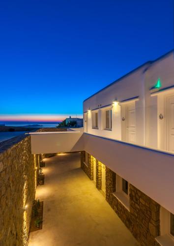 a house with a view of the ocean at night at Cape Mykonos in Mýkonos City