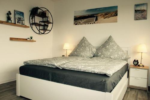 a bedroom with a bed with two pillows on it at Jan am Strand 315 in Cuxhaven