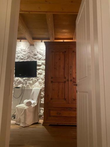 a room with a door and a tv and a chair at Arachova5634 in Arachova
