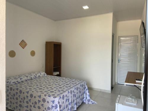 a small bedroom with a bed and a window at BL Maria Bonita Pousada in Maragogi