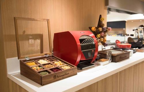 a bakery counter with a red toaster on a counter at Richmond Hotel Utsunomiya-ekimae Annex in Utsunomiya