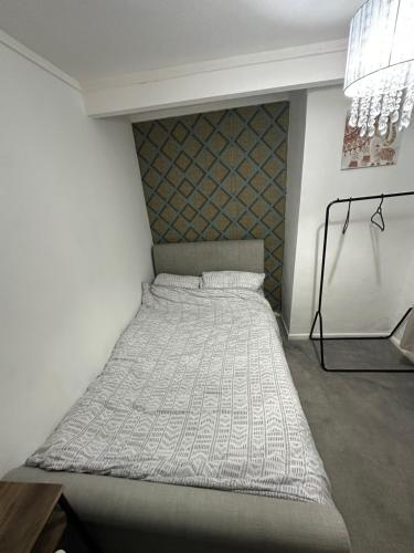 a large bed in a room with a wall at Gloucester in Gloucester