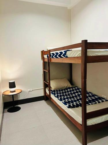 a room with two bunk beds and a table at Spacious Apartment Unit in Daro, Dumaguete City in Dumaguete