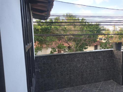 an open door to a balcony with a view at Calango's Beach-House-Arraial do Cabo in Arraial do Cabo