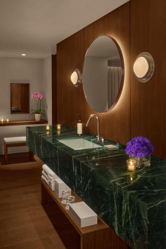 a bathroom with a large green marble sink and a mirror at The Tokyo EDITION, Ginza in Tokyo