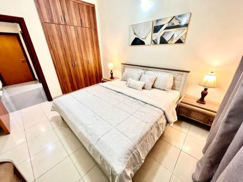 a bedroom with a bed with two pillows on it at Stay at Al Ghaimah Holiday Homes 1 Bedroom Apartment Near Airport in Dubai