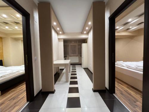 a hallway with two beds and a desk in a room at Royal Brown Property in Oradea