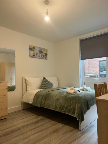 a bedroom with a bed and a window at Lovely Triple and Quadruple Bedrooms in Euston in London