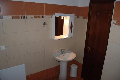 a bathroom with a sink and a window at Nikos Apartments in Ioannina