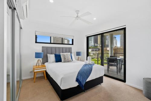 a bedroom with a king sized bed and a balcony at Spice Broadbeach - GCLR in Gold Coast