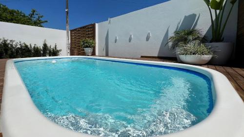 una gran piscina junto a una casa en Casa 4 quartos piscina praia Mariscal Bombinhas SC, en Bombinhas