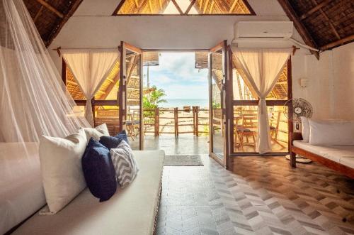 a living room with a white couch and a window at Surya Beach Resort Palawan in Aborlan