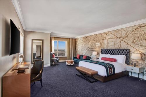 um quarto de hotel com uma cama, uma secretária e uma televisão em Hotel Paso Del Norte, Autograph Collection em El Paso