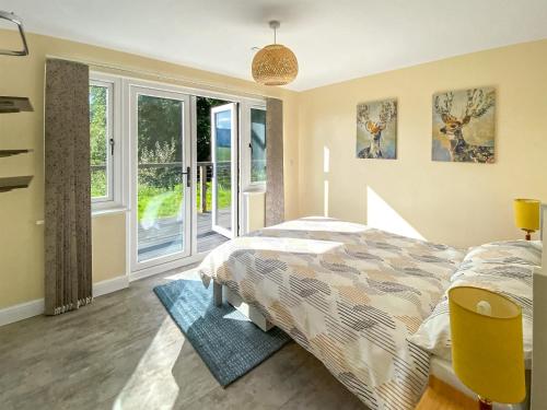 a bedroom with a bed and a window at The Old Stables in Presteigne