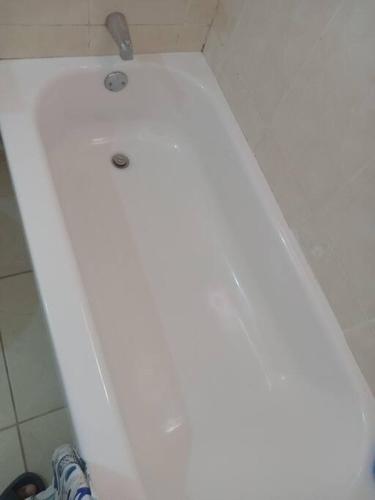 a white toilet with a shower in a bathroom at Cheerful 2-Bedroom Home in Falmouth Garden in Falmouth