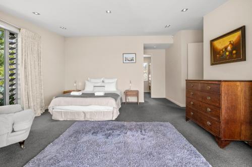 a bedroom with a bed and a dresser and a couch at Hepina Heights Retreat - Kinloch in Kinloch