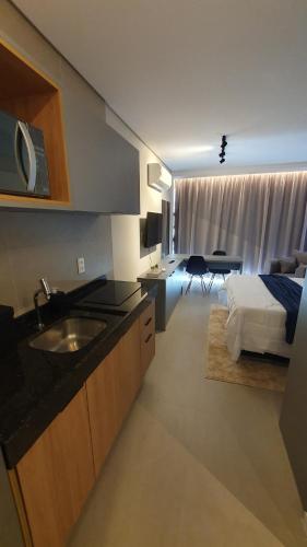 a kitchen with a sink and a bed in a room at Flat Novo em Boa Viagem - Rooftop 470 in Recife
