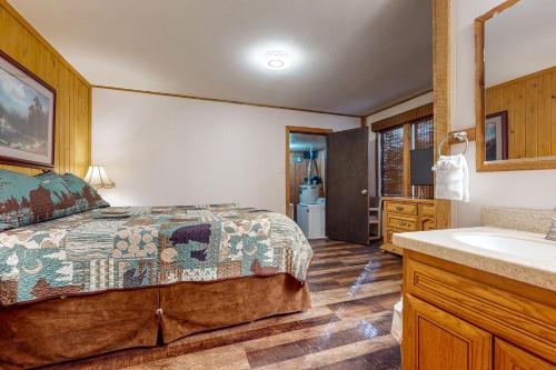 a bedroom with a bed and a bathroom with a sink at Donner Escape in South Lake Tahoe