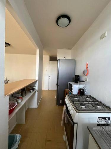 a kitchen with a stove and a refrigerator at Apartamento amoblado 124 Ovalle in Ovalle