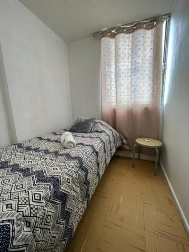 a bedroom with a bed with a dog laying on it at Apartamento amoblado 124 Ovalle in Ovalle