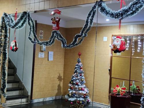 a christmas tree in a hallway with christmas decorations at Ana Dpto in Mar del Plata