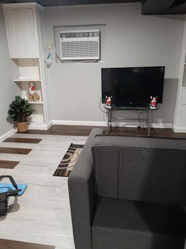 a living room with a couch and a flat screen tv at MJD Havens in Washington