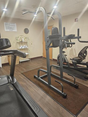 a gym with several tread machines in a room at Ramada by Wyndham SeaTac Airport in SeaTac
