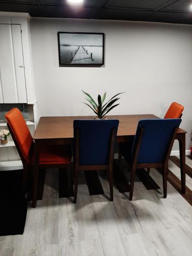 a dining room table with chairs and a potted plant at MJD Havens in Washington