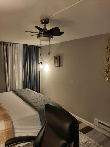 a bedroom with a bed and a ceiling fan at MJD Havens in Washington