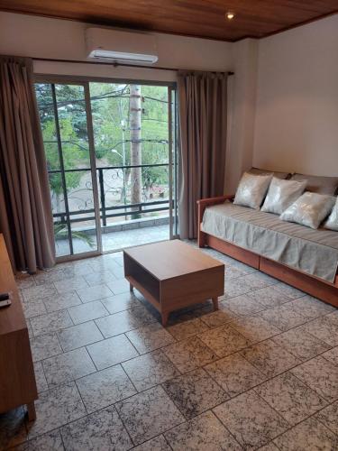 a living room with a couch and a coffee table at Departamento La Plaza in La Falda