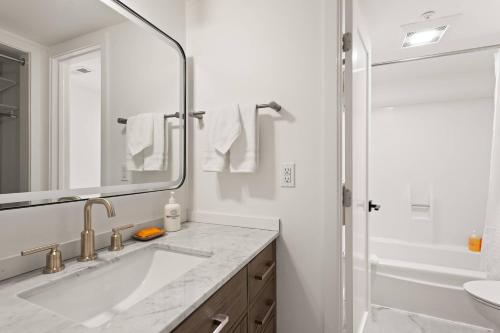a white bathroom with a sink and a shower at Aspenwood Studio with Loft- J12 in Snowmass Village