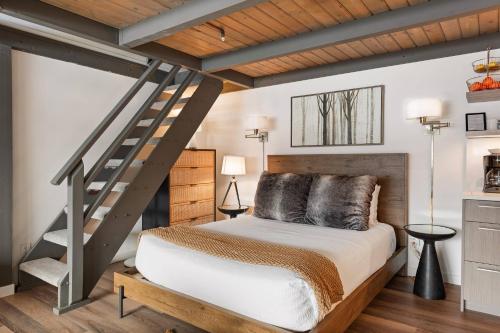 a bedroom with a loft bed and a staircase at Aspenwood Studio with Loft- J12 in Snowmass Village