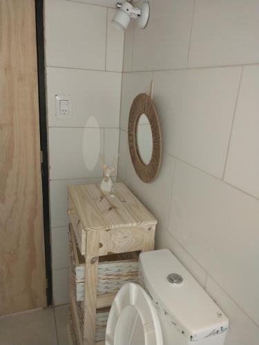a small bathroom with a toilet and a mirror at Casa la buena vida in San Rafael