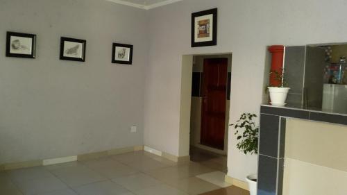 a living room with three pictures on the wall at Monarchy Guest House in Johannesburg