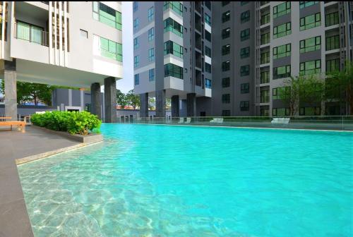 a large swimming pool in the middle of a building at The Base Central Pattaya in Pattaya Central