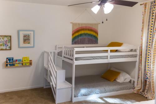 a childs bedroom with two bunk beds and a rainbow at Home Away from Home in Spring in Spring