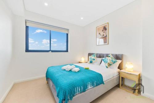 a bedroom with a bed with a blue blanket at Entire apartment in Arncliffe in Sydney