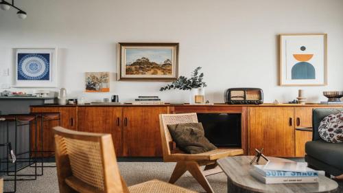 a living room with a wooden entertainment center at Dusk Coffin Bay in Coffin Bay