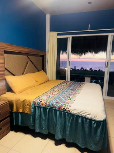a bedroom with a bed with a view of the ocean at Brisa Del Mar #1 in Puerto Escondido