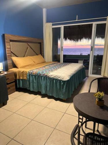 a bedroom with a bed with a view of the ocean at Brisa Del Mar #1 in Puerto Escondido