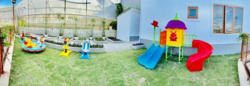 a backyard with a playground with a slide at Nathy Villa in Khu Chi Lăng