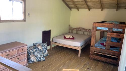 1 dormitorio con 2 literas y suelo de madera en Toca do Siri, en Imbituba