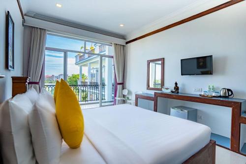 a bedroom with a large bed and a balcony at Kampot View Boutique in Kampot