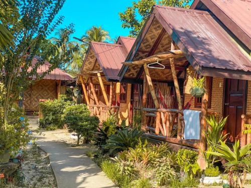 a wooden house with a red roof at Eashantis Place in San Vicente