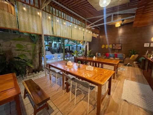 a dining room with wooden tables and chairs at Teteng's Home in San Vicente