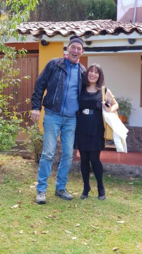 a man and a woman standing in front of a house at EColodge Ccatan in Urubamba