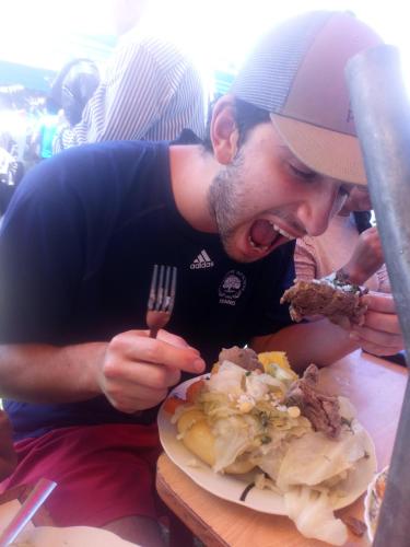 a man holding a fork and a plate of food at EColodge Ccatan in Urubamba